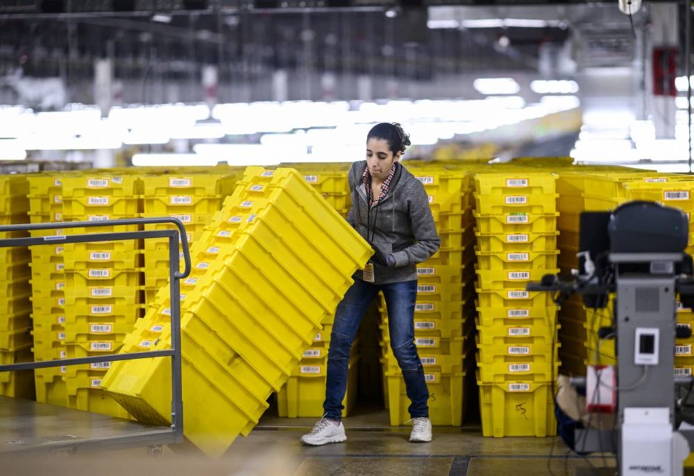 In this file photo, a woman works at a distribution station at the 855,000-square-foot Amazon fulfillment center in Staten Island, one of the five boroughs of New York City, on February 5, 2019. AFP PHOTO